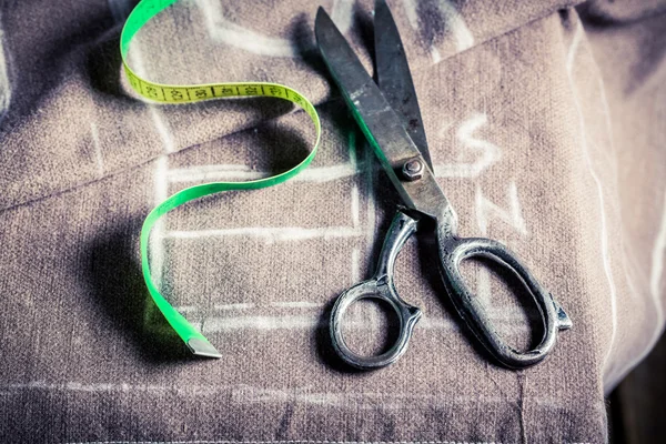 Old sewing table with scissors and cloth — Stock Photo, Image