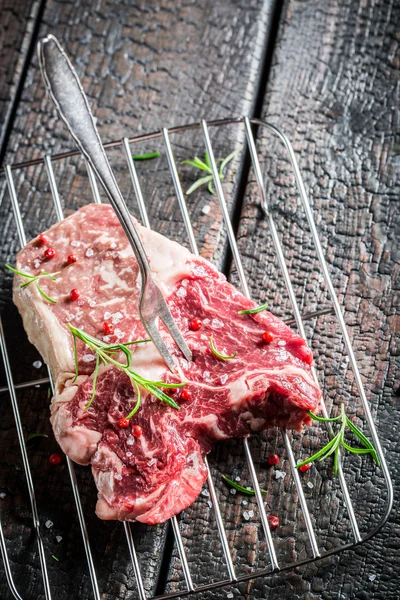 Fresh piece of beef with rosemary and pepper — Stock Photo, Image