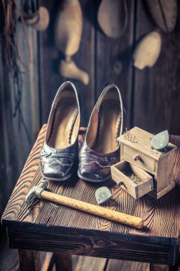 Old cobbler workshop with brush and shoes clipart
