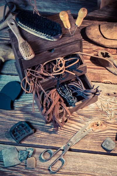 Shoemaker workplace with tools, leather and shoes — Stock Photo, Image