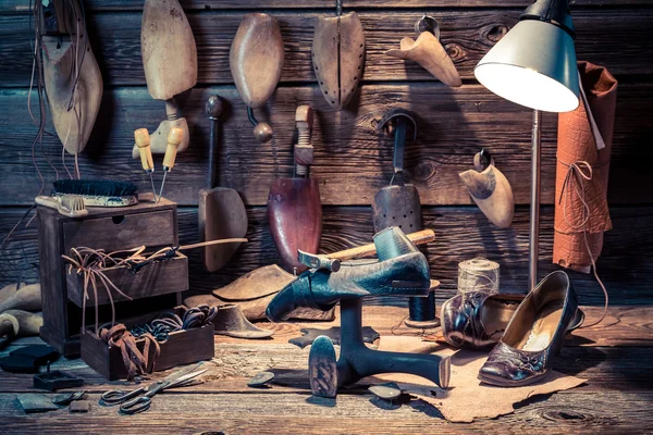 Vintage skomakare workshop med skor, skosnören och verktyg — Stockfoto