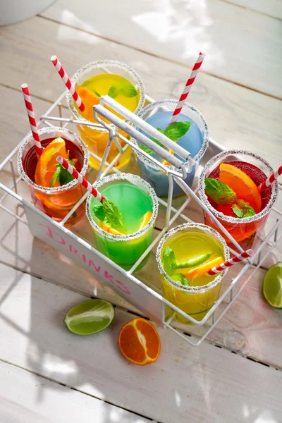 Sweet lemonade with straw and fruits — Stock Photo, Image