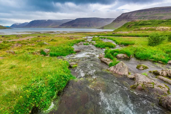 River flows from a waterfall, Iceland — Stock Photo, Image