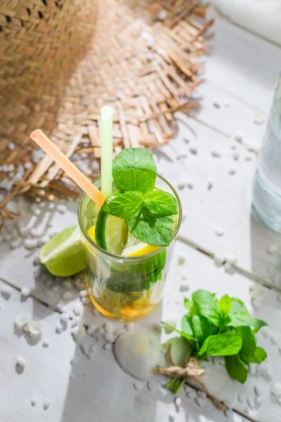 Tasty drink with lemon, lime and sugar — Stock Photo, Image