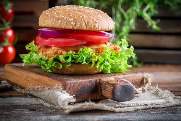 Closeup of tasty burger with vegetables — Stock Photo, Image