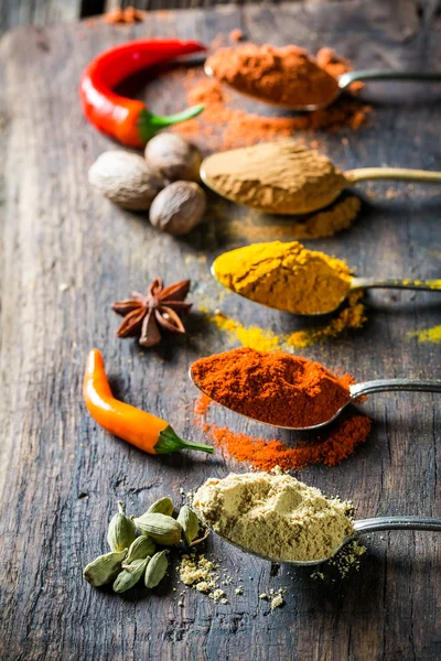Tasty herbs and spices on old spoons — Stock Photo, Image