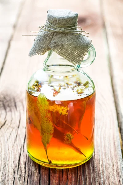 Healthy herbs in bottles made of honey and linden — Stok fotoğraf