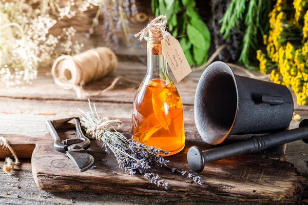 Aromatic herbs in bottles with honey as cure — Stock Photo, Image
