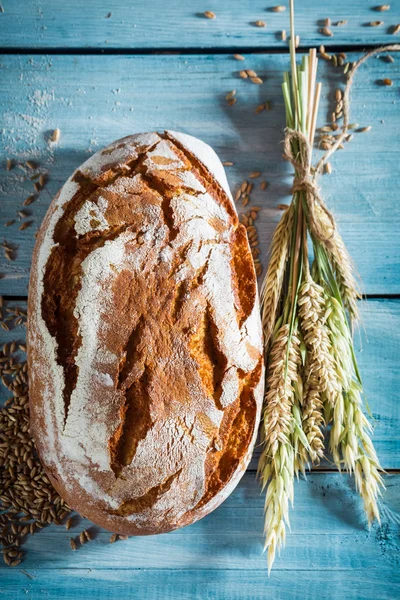 Healthy bread with whole grains on blue table — Stock Photo, Image