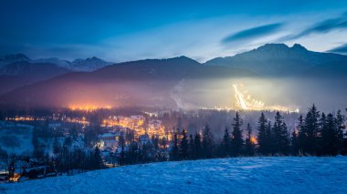 Zakopane during the skiing competitions at dusk in winter, Poland clipart
