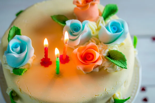 Sweet birthday cake decorated with candles and roses — Stock Photo, Image