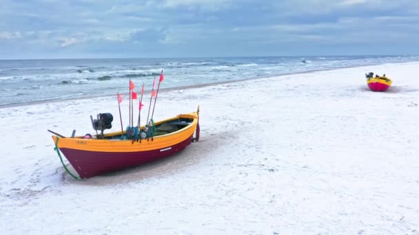 Łódka rybacka na zaśnieżonej plaży na Bałtyku w zimie. — Wideo stockowe