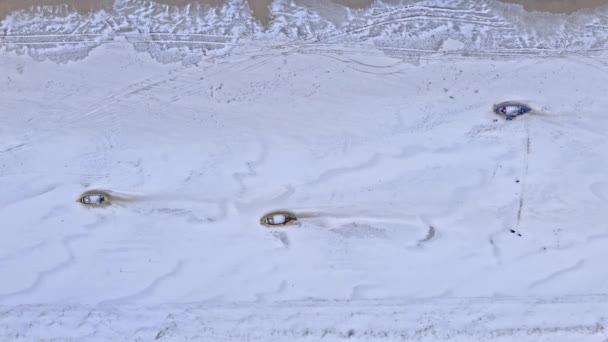 Łodzie zimą na śnieżnej plaży nad Morzem Bałtyckim. — Wideo stockowe