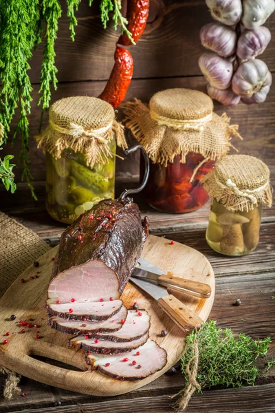 Freshly sliced smoked ham and marjoram — Stock Photo, Image