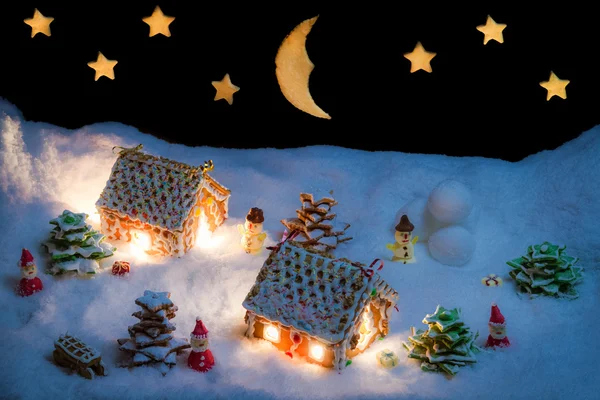 白雪皑皑的姜饼村庄与星星和月亮 — 图库照片