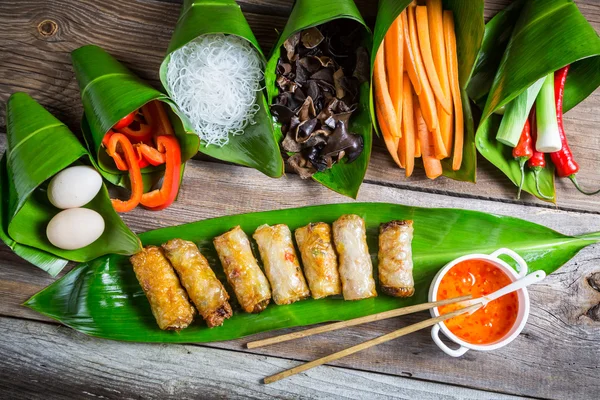 Gebratene Frühlingsrollen umgeben von Zutaten — Stockfoto