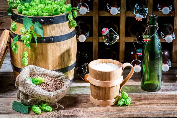 Beer served in a wooden mug in the cellar — Stock Photo, Image