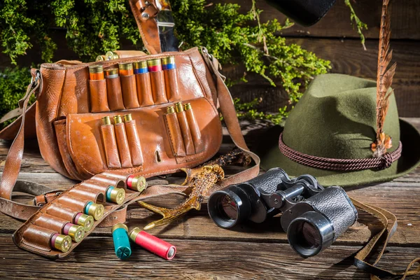 Bag, bullets and hat in a hunting lodge — Stock Photo, Image
