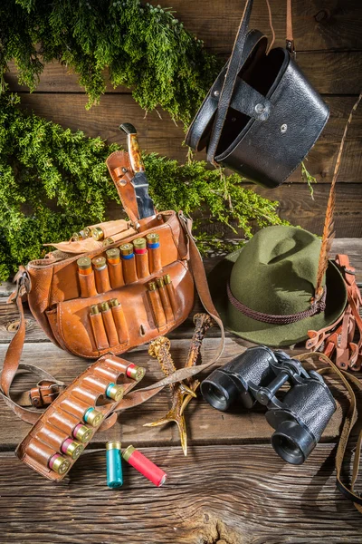 Bag, bullets and hat in a hunting lodge