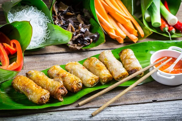 Fried spring rolls surrounded by ingredients — Stock Photo, Image