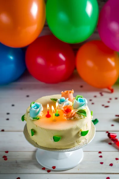 Sweet cake with candles on a birthday party — Stock Photo, Image