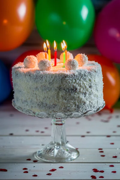 Coconut cake with candles on birthday — Stock Photo, Image