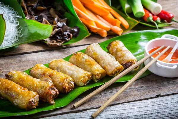 Fried spring rolls surrounded by ingredients — Stock Photo, Image