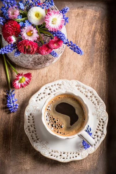 Coffee and spring flowers on old wooden tray — Stock Photo, Image