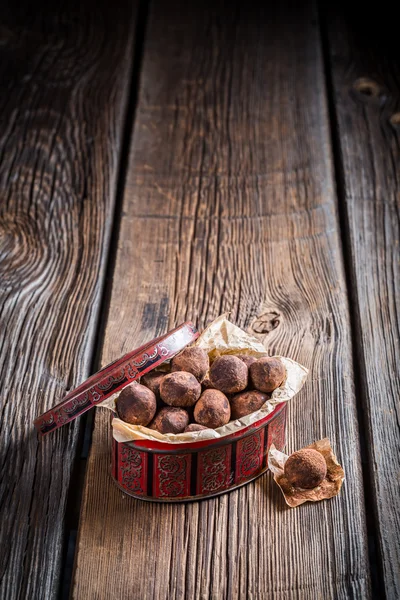 Sweet brown balls in red box — Stock Photo, Image
