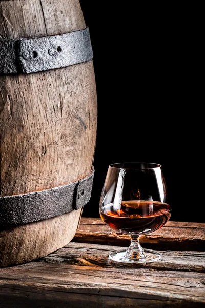 Glass of cognac in the old cellar — Stock Photo, Image