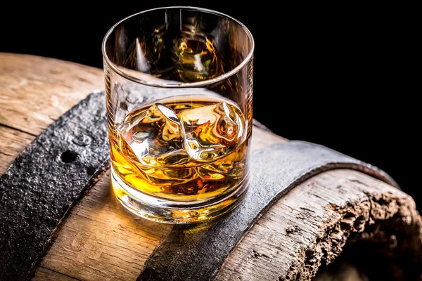 Bicchiere di whisky e vecchio barile di legno — Foto Stock