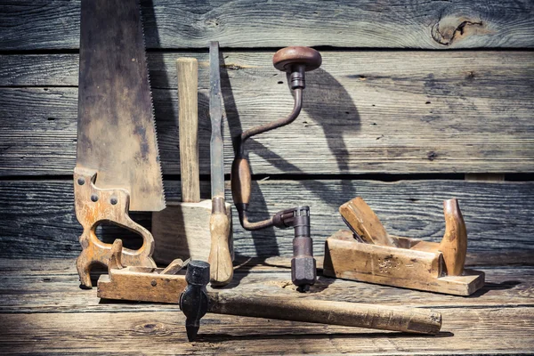 Hammer, saw and chisel on carpentry workbench — Stock Photo, Image