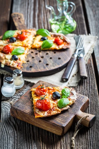 Closeup of freshly baked pizza with cheese and basil — Stock Photo, Image