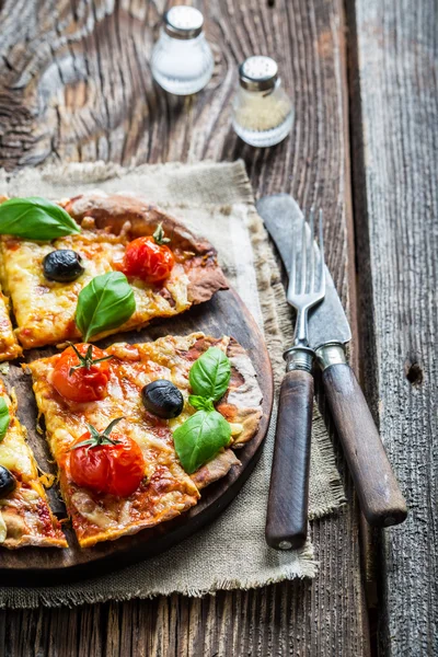 Homemade pizza with mushrooms on baking paper — Stock Photo, Image