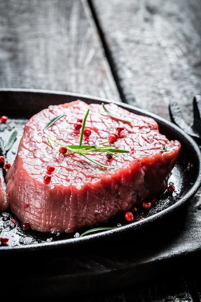Grilling fresh piece of beef with herbs — Stock Photo, Image