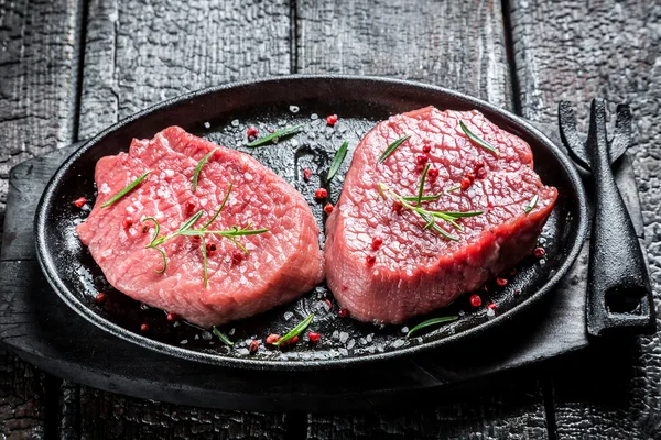 Grilling fresh piece of red meat with rosemary — Stock Photo, Image