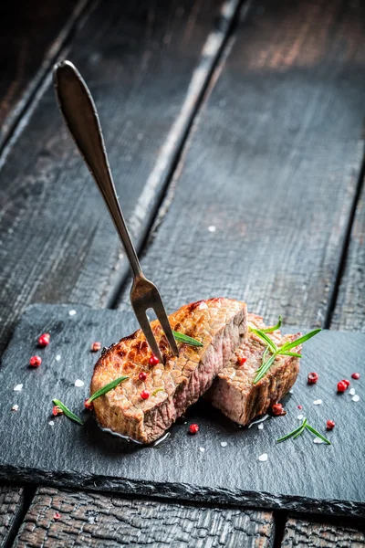 Hot grilled meat with fresh rosemary on plate — Stock Photo, Image