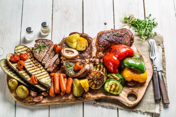 Verduras a la parrilla y bistec con hierbas en la mesa blanca —  Fotos de Stock