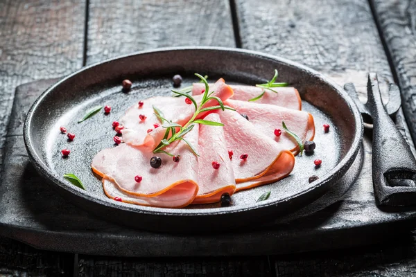 Tasty cold cuts with pepper and herbs — Stock Photo, Image