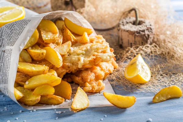 Delicioso bacalao con patatas fritas servido en papel — Foto de Stock