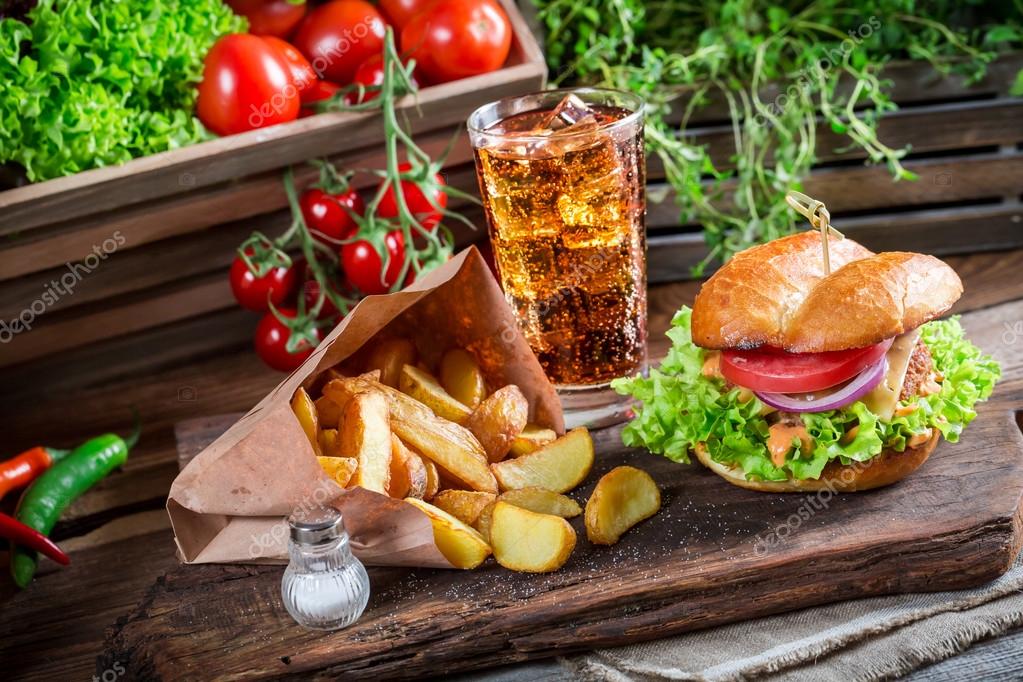 Tasty chicken burger with cold drink and fries — Stock Photo