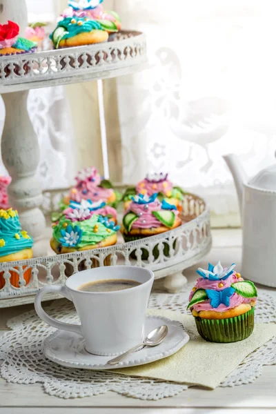 Tasty cupcakes with sweet decoration and coffee — Stock Photo, Image