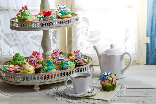 Tasty muffins with cream and sweet decoration — Stock Photo, Image