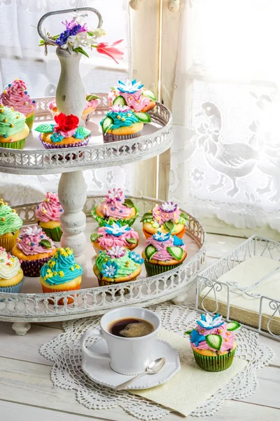 Tasty cupcakes with cream and sweet decoration — Stock Photo, Image