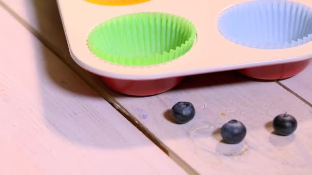 Pouring blueberry dough to cookie cutters — Stock Video