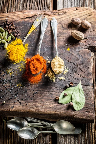 Colorful spices and herbs on old table — Stock Fotó