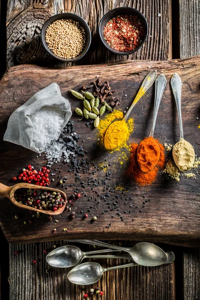Fresh herbs and spices on old board — Stock Photo, Image