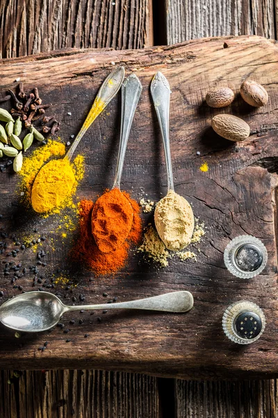 Various herbs and spices on old board — Stock Photo, Image