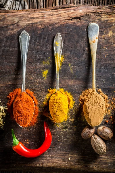 Various spices and herbs on old board — Stock Fotó