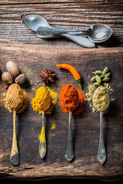 Tasty herbs and spices on old board — Stock Fotó